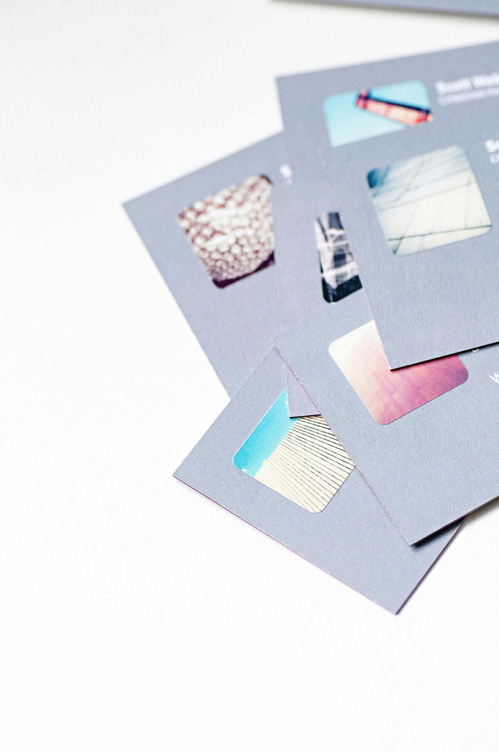 High angle view of abstract design business cards with cutouts on a white background.